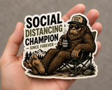 Social Distancing Champion Sticker | Bigfoot Decal — real sticker held in hand